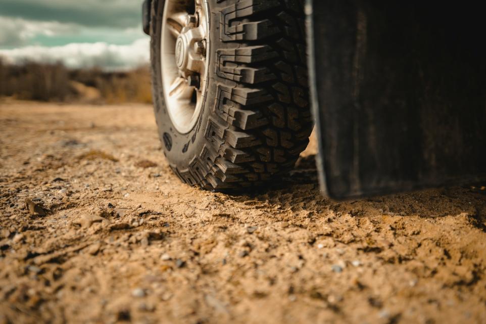 black car tire on brown sand during daytime